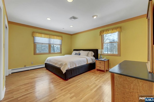 bedroom with recessed lighting, visible vents, a baseboard heating unit, light wood-style floors, and ornamental molding