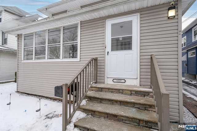 view of snow covered property entrance