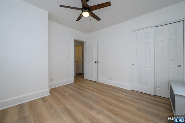 unfurnished bedroom with ceiling fan, light hardwood / wood-style floors, and a closet