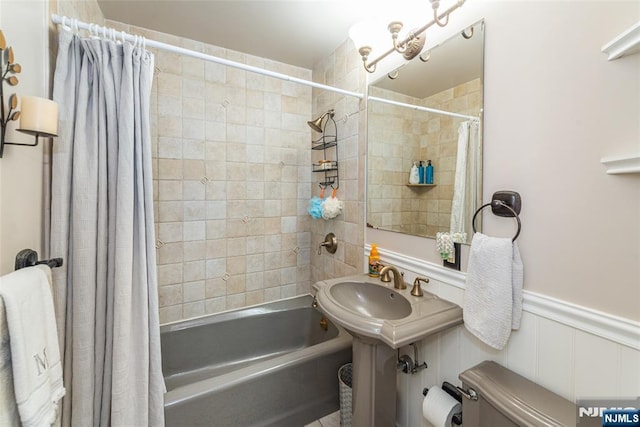 bathroom with shower / tub combo with curtain and toilet