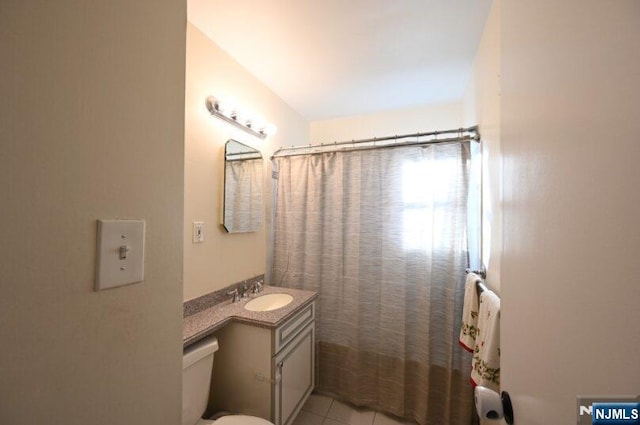 bathroom featuring toilet, vanity, and tile patterned floors