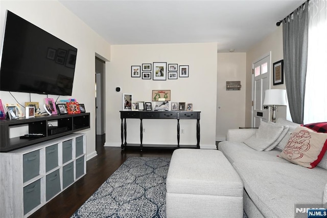 living room with baseboards and dark wood-style flooring