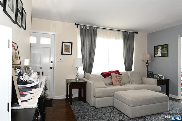 living area featuring dark wood finished floors and baseboards