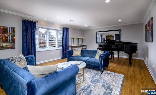 living room featuring ornamental molding, visible vents, baseboards, and wood finished floors