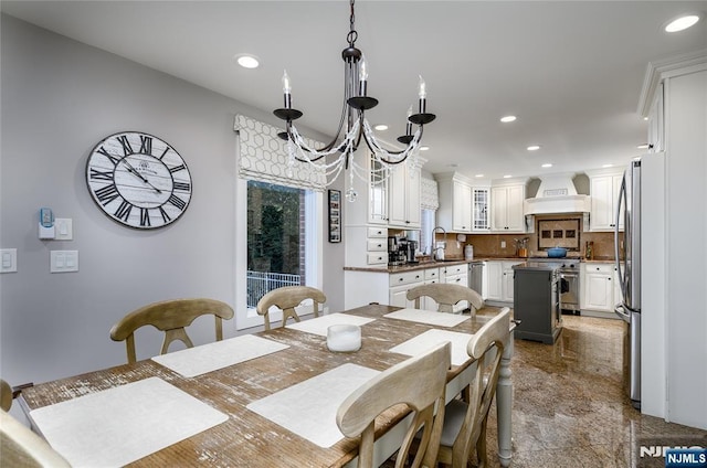 dining area with a notable chandelier and recessed lighting