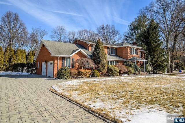 view of front of property with a garage and brick siding