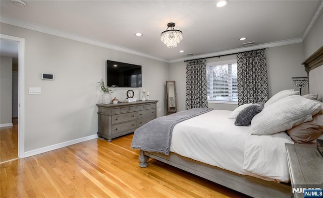 bedroom featuring light wood-style floors, visible vents, crown molding, and baseboards