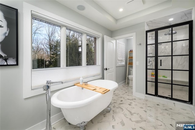 bathroom with toilet, recessed lighting, baseboards, marble finish floor, and a soaking tub