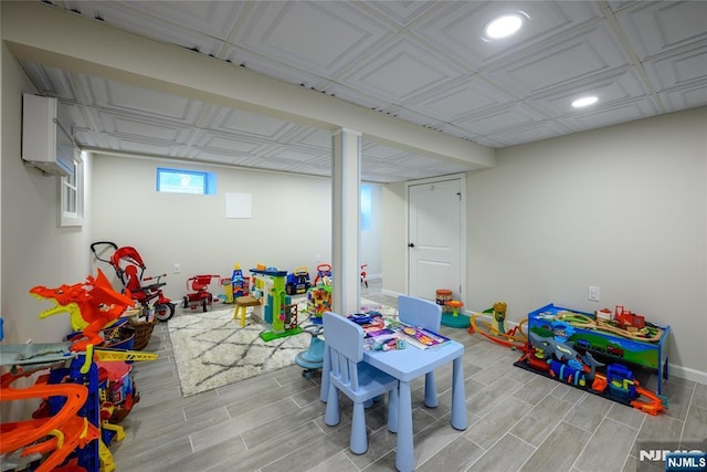 playroom with wood tiled floor, baseboards, and recessed lighting