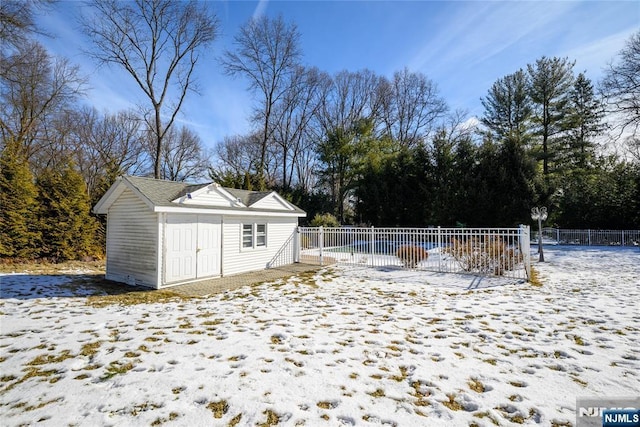 yard covered in snow with fence and a swimming pool