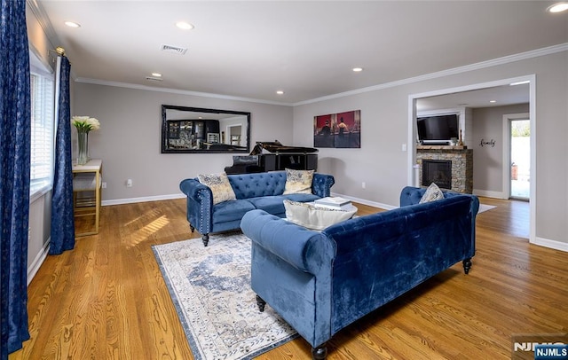 living room with light wood-style floors, a healthy amount of sunlight, and visible vents