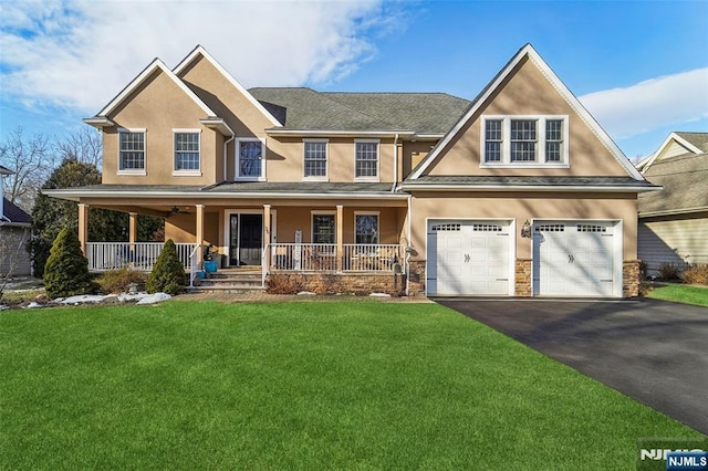 view of front of home featuring stucco siding, a porch, a garage, driveway, and a front lawn