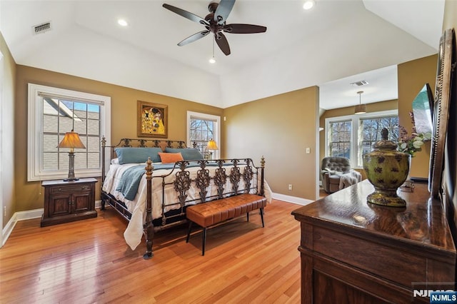 bedroom featuring lofted ceiling, visible vents, and light wood-style floors