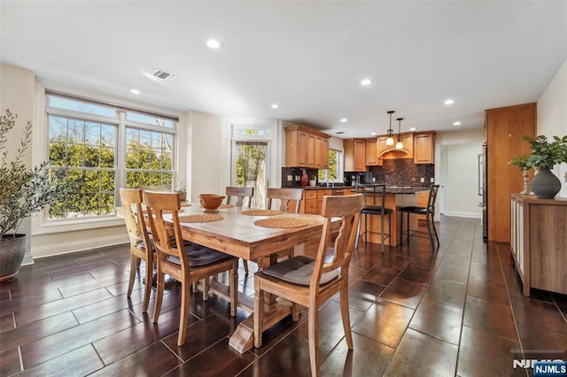 dining area featuring baseboards, plenty of natural light, visible vents, and recessed lighting