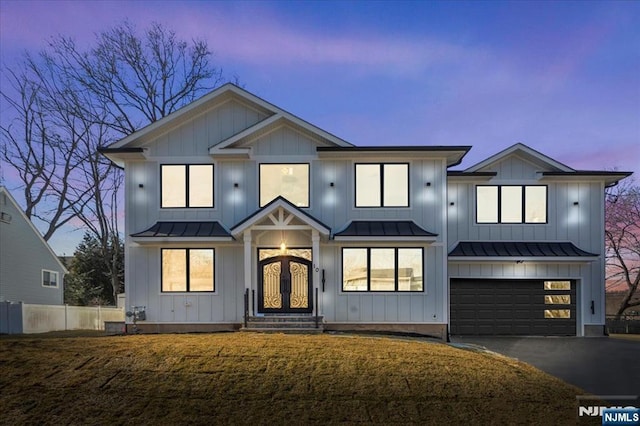 modern inspired farmhouse with a garage