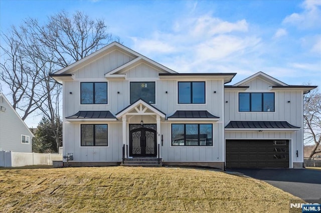 modern farmhouse style home with a garage and a front yard