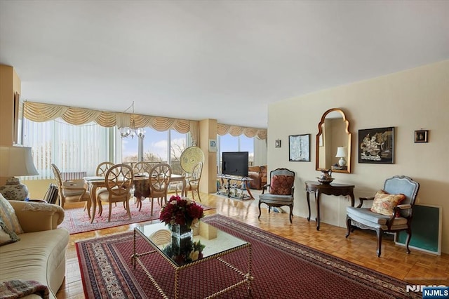 living room with parquet floors, plenty of natural light, and a notable chandelier