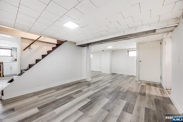 basement with light hardwood / wood-style floors