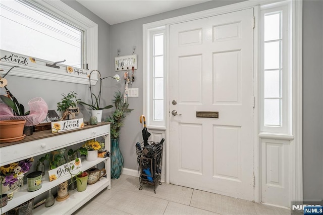 tiled entryway with a healthy amount of sunlight