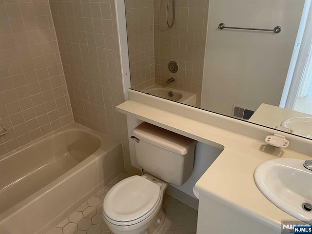 bathroom featuring tub / shower combination, a sink, toilet, and tile patterned floors