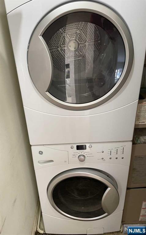 laundry room featuring laundry area and stacked washer / drying machine