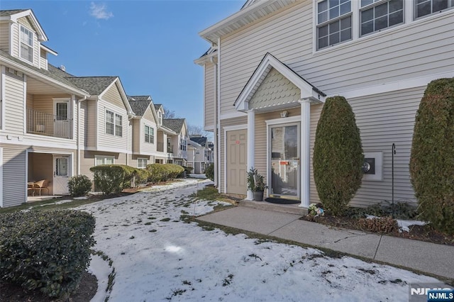 view of snow covered property entrance