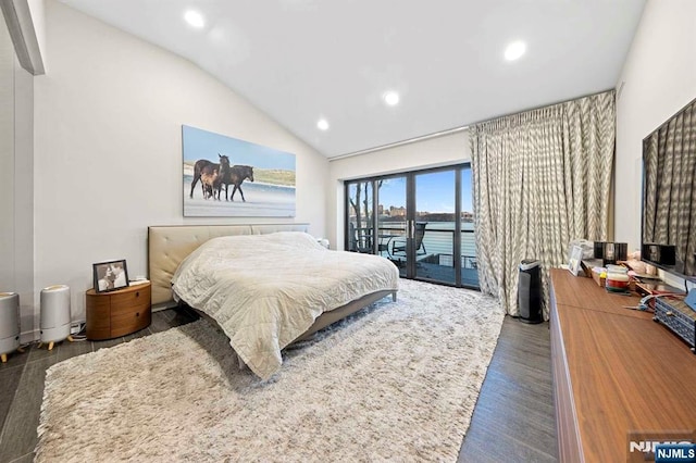 bedroom with dark hardwood / wood-style flooring, access to exterior, and vaulted ceiling