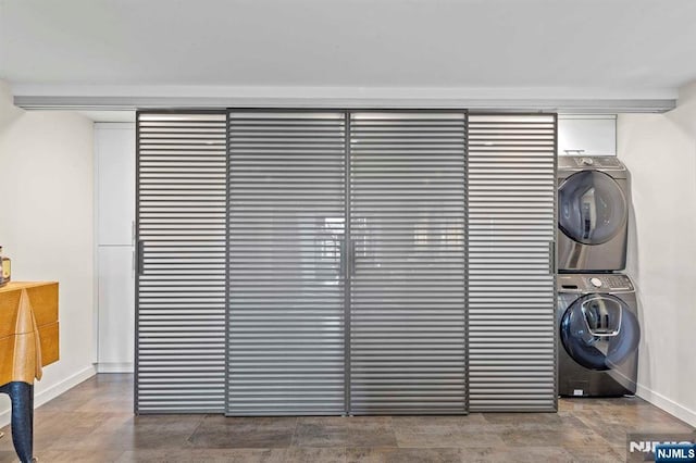 interior space with stacked washer and clothes dryer