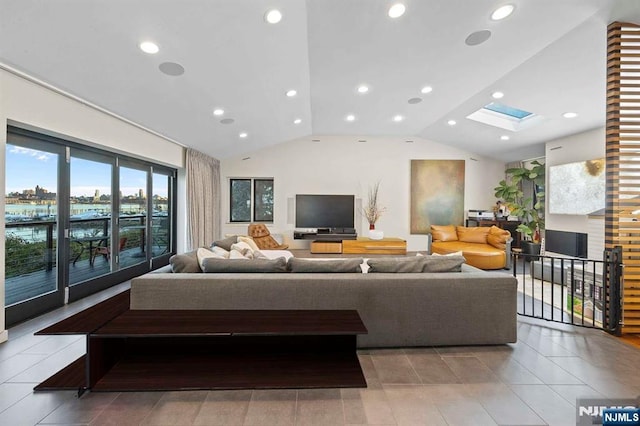 tiled living room featuring lofted ceiling with skylight