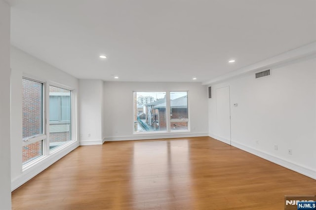 unfurnished room with light hardwood / wood-style flooring