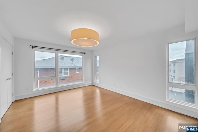 unfurnished room with light hardwood / wood-style flooring