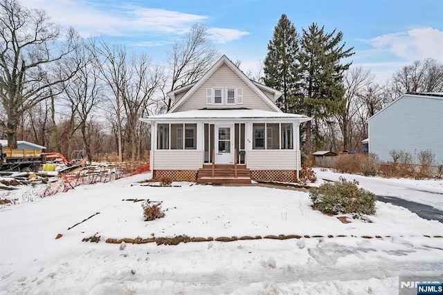 view of front of house with a sunroom