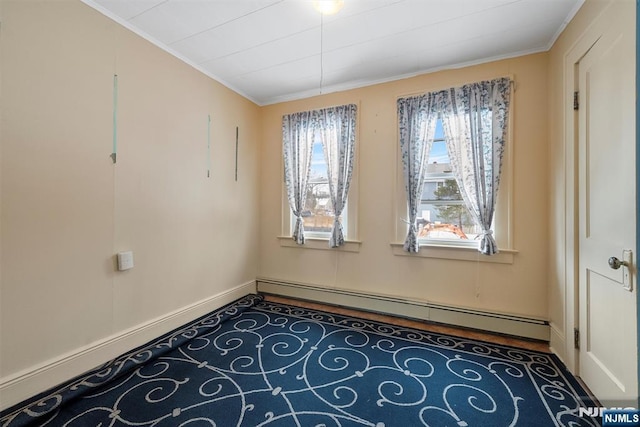 spare room featuring ornamental molding and baseboard heating