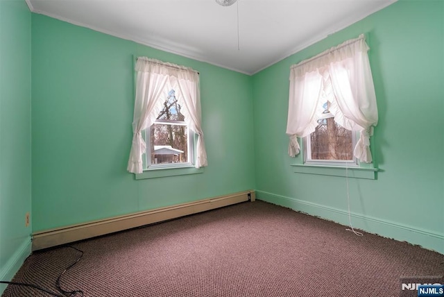 carpeted empty room featuring baseboard heating