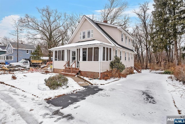 view of front of house with a sunroom