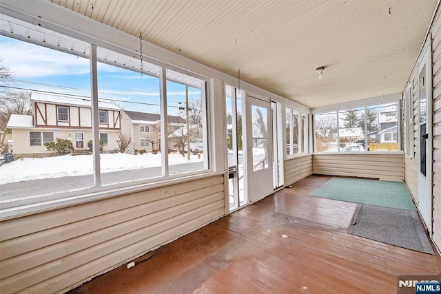 unfurnished sunroom with plenty of natural light