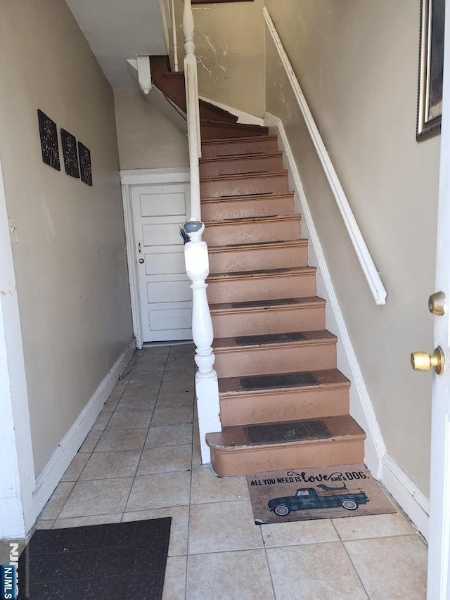 stairway featuring tile patterned floors