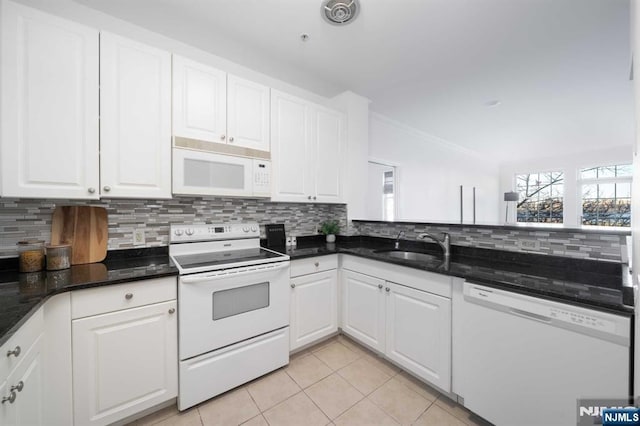 kitchen featuring light tile patterned flooring, white cabinetry, sink, decorative backsplash, and white appliances