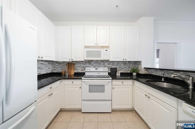 kitchen with sink, light tile patterned floors, white cabinets, and white appliances