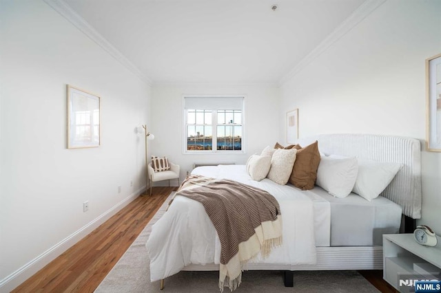 bedroom featuring ornamental molding and hardwood / wood-style floors