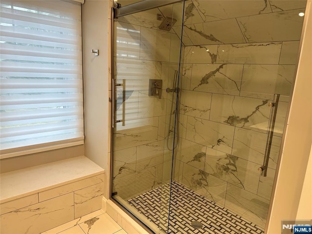 bathroom with a shower with shower door