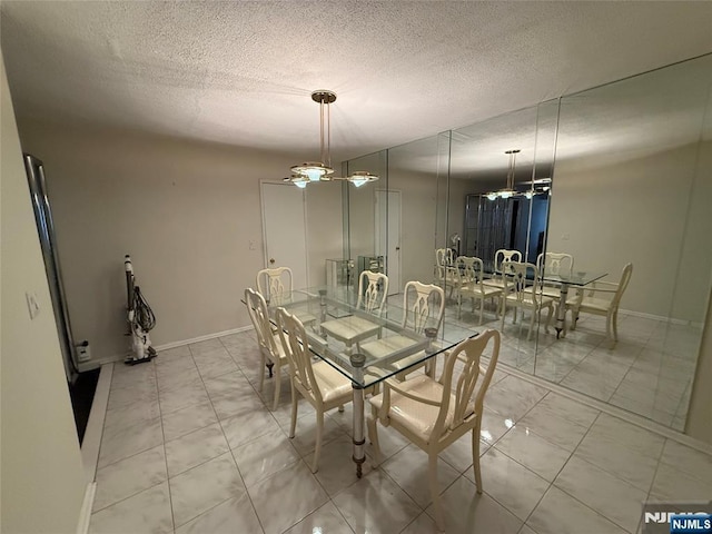 tiled dining area with a textured ceiling