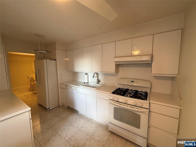 kitchen featuring white appliances, sink, and white cabinets