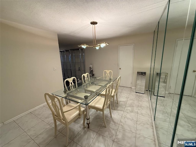 dining room featuring an inviting chandelier and a textured ceiling