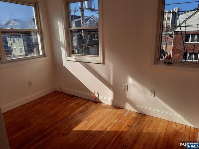 unfurnished room featuring wood-type flooring