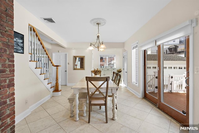 dining space with stairs, light tile patterned flooring, visible vents, and baseboards