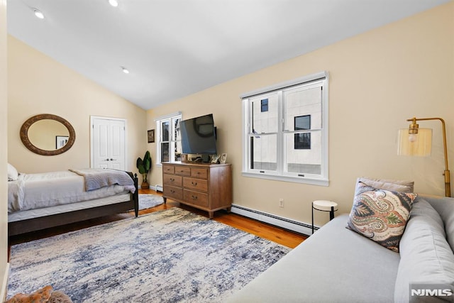 bedroom featuring a baseboard radiator, lofted ceiling, recessed lighting, and wood finished floors