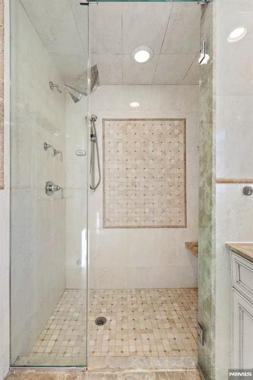 full bathroom featuring a stall shower and vanity