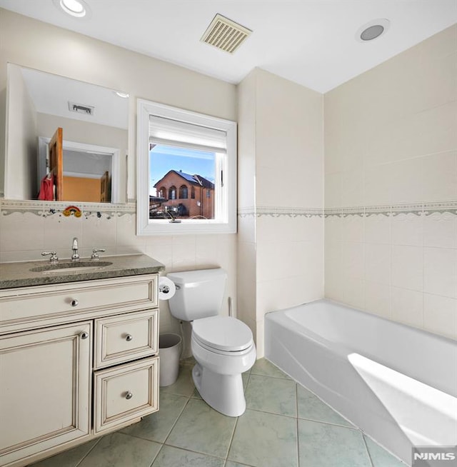 bathroom with visible vents, tile walls, toilet, and tile patterned floors