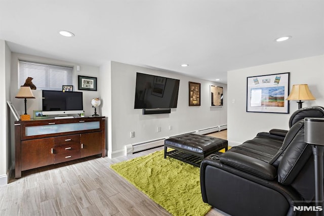 living area featuring light wood-style flooring, a baseboard heating unit, baseboards, and recessed lighting